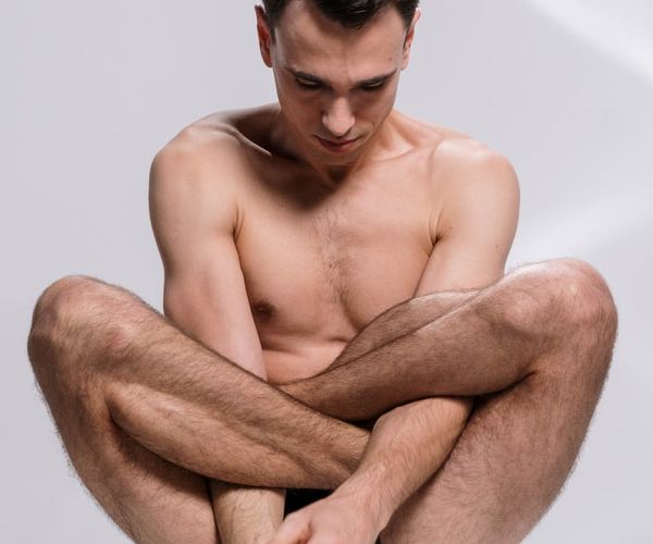 A man in a focused pose showing balance and body control.